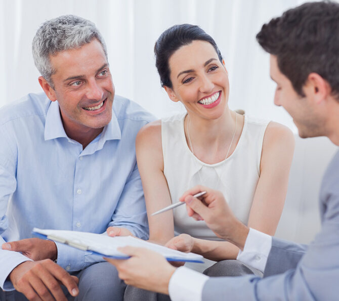 Business people talking together on sofa at office